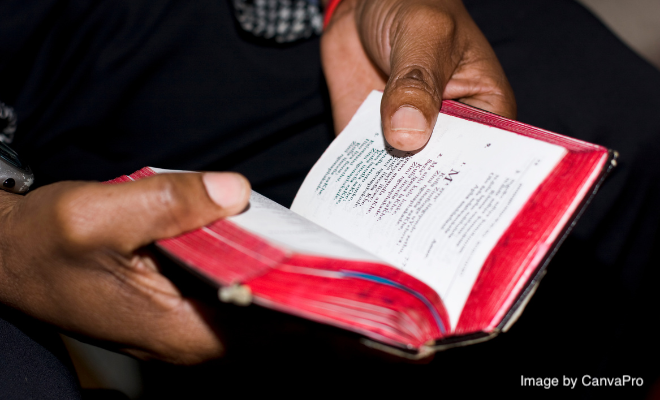 Image of hands holding a sacred book from Canva Pro.