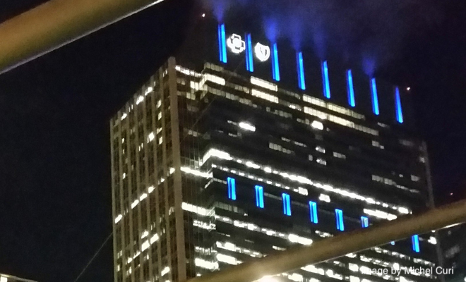 JPEG image of the Blue Cross Blue Shield Tower from "Jay Pritzker Music Pavilion," a Wikimedia Commons photograph by Michel Curi. Link: https://commons.wikimedia.org/wiki/File:Jay_Pritzker_Music_Pavilion_(14854942694).jpg